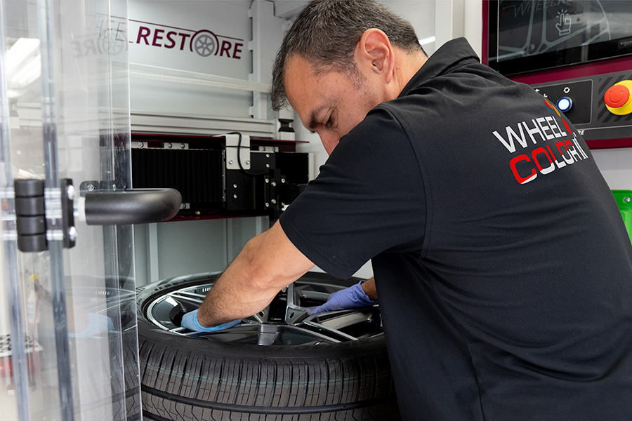 technician performing wheel repair service on alloy wheel